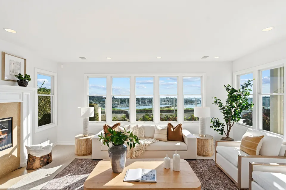 Family room with a fireplace and windows across the back