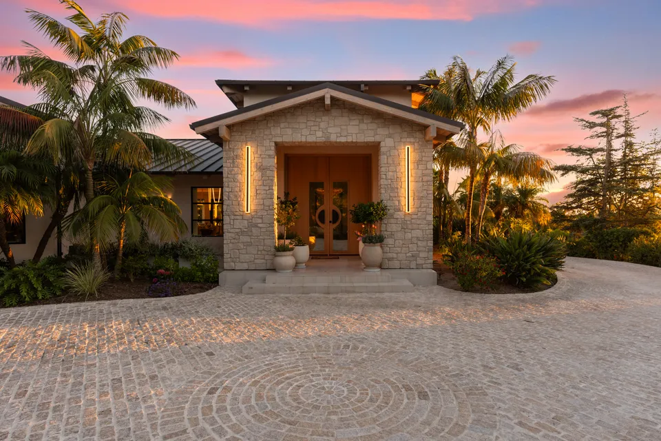 Stone entry with double doors at dusk