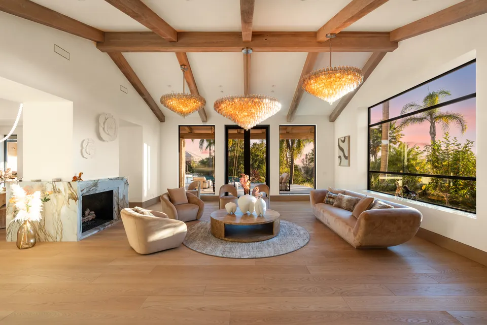 Living room with a beamed ceiling and a fireplace
