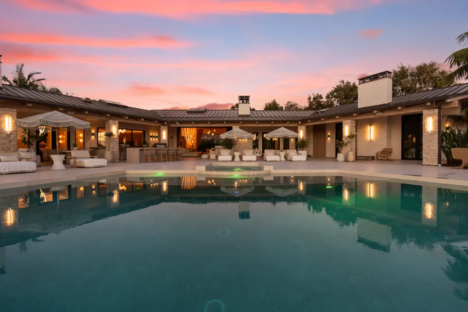 Pool and terraces with the lights on at dusk
