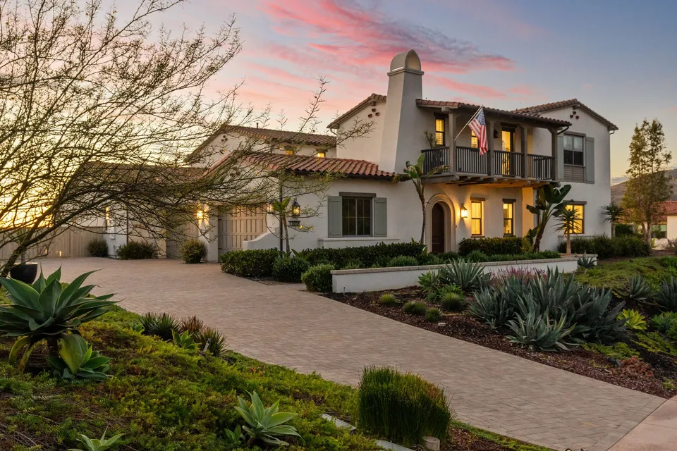 Spanish-style home and motor court at sunset