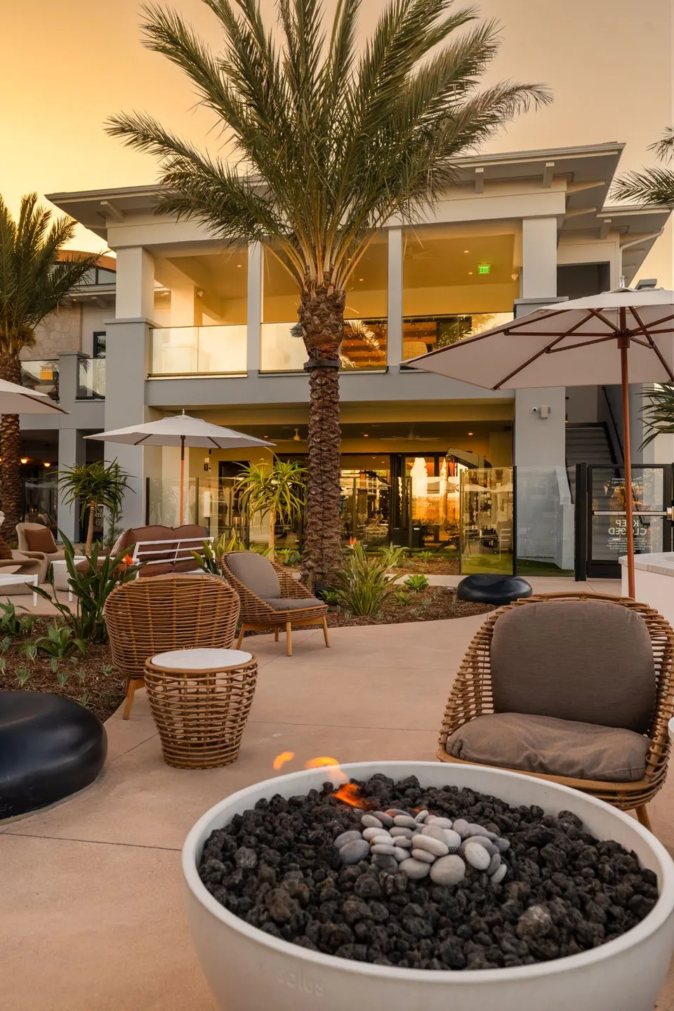 Fire pit seating outside the clubhouse at dusk