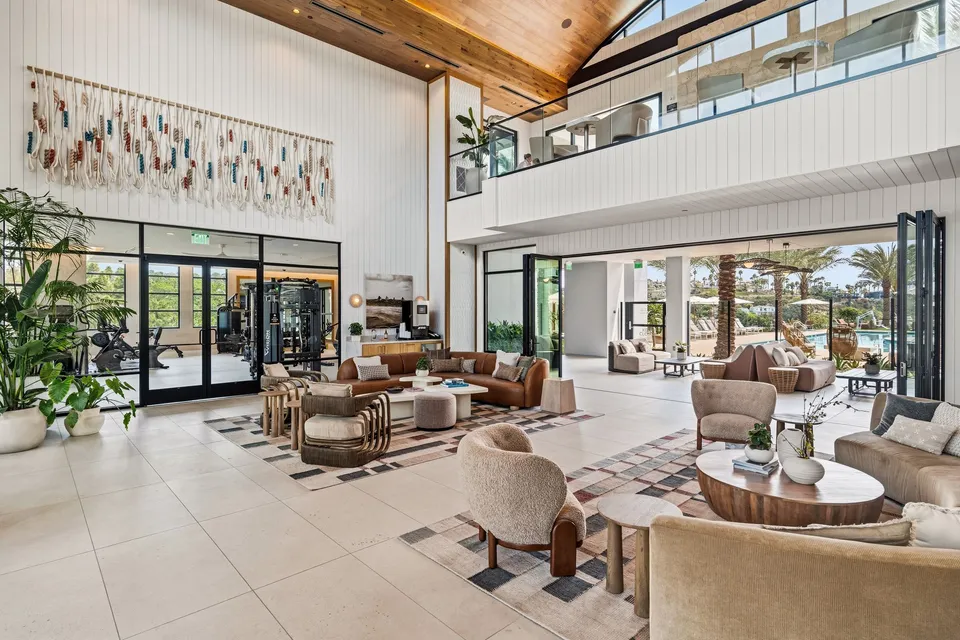 Two-story lobby lounge with a woven wall hanging