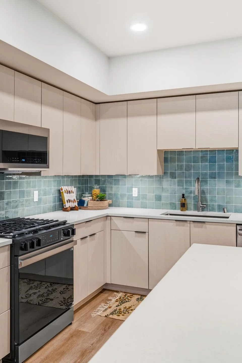 Model apartment kitchen with a tiled backsplash